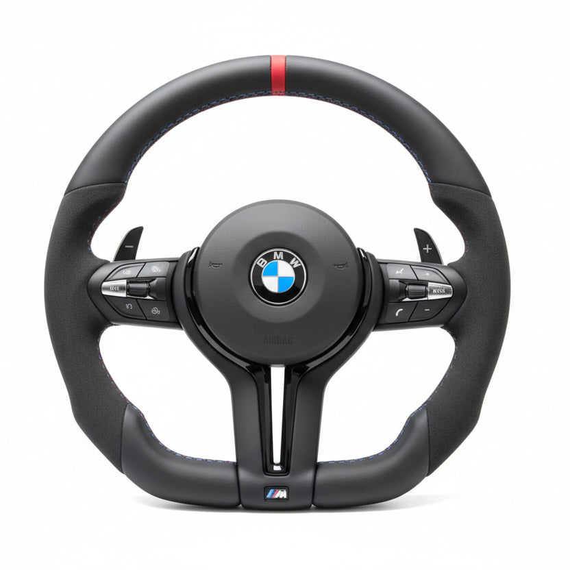 Black steering wheel with BMW logo on a beige surface
